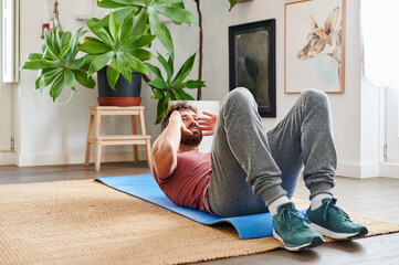 Man doing sit-ups at home