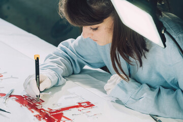 Architect working on small scale architectural model .