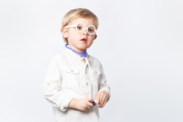 Funny kid doctor with glasses and stethoscope on light background with copy space