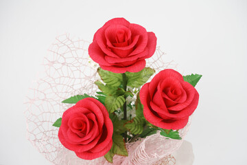Bouquet of flower(paper red rose) in the center vertical for love of a couple