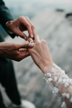 groom ringing bride with golden diamond ring