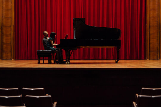 Man and woman, playing a piano
