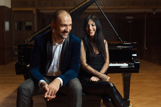 Man and woman, playing a piano