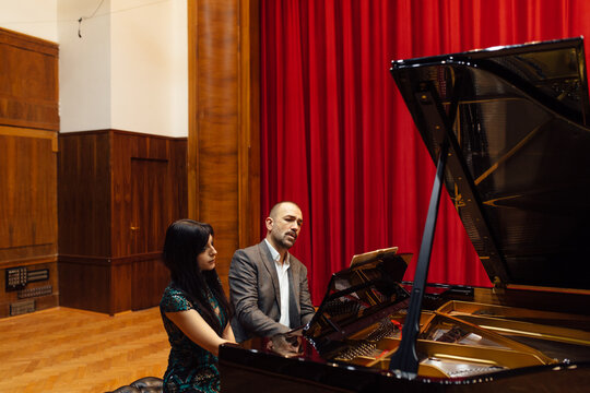 Man and woman, playing a piano