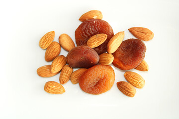 Natural dry fruits on white background, almonds and apricots