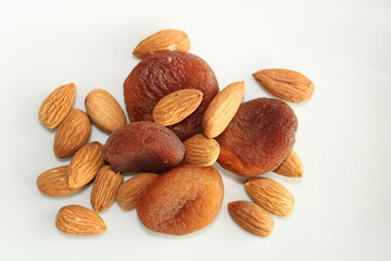 Natural dry fruits on white background, almonds and apricots