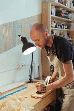 A violin artisan in his workshop.
