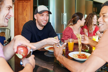 People having dinner in hostel kitchen