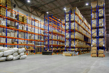 Interior of a modern warehouse storage of retail shop with pallet truck near shelves