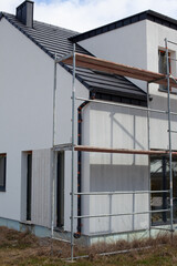 Modern house construction with scaffold pole platform. New build domestic building.
