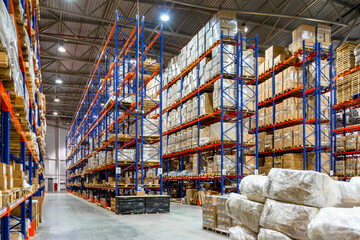 Interior of a modern warehouse storage of retail shop with pallet truck near shelves