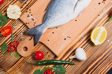 Raw dorado fish with spices cooking on cutting board. Fresh fish dorado