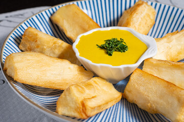Peruvian traditional food. Fried yucca with sauce