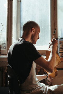 A violin artisan in his workshop.