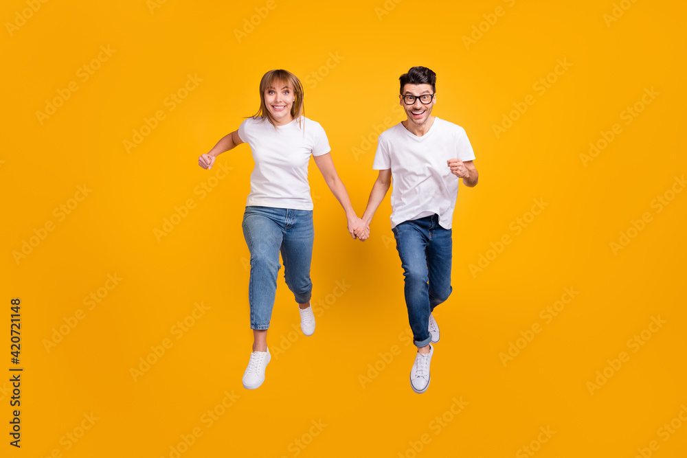 Canvas Prints full length photo of funny sweet two persons dressed white t-shirt running jumping holding arms isol