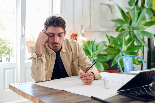 Architect going over blueprints at work