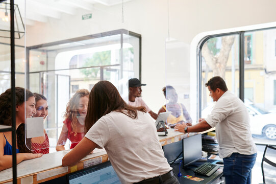 Young people checking in to a youth hostel