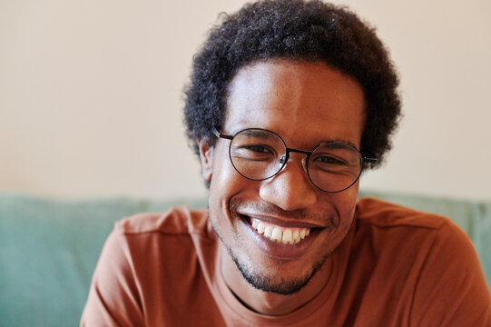 Smiling young man sitting at home