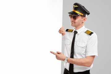Male pilot pointing at a blank poster © kegfire