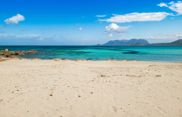 Fototapeta na wymiar Panoramic view of Pittulongu beach, in the background the island of Tavolara, Olbia - Sardinia