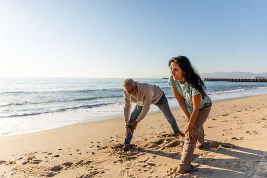 Senior Couple Does A Deep Stretch