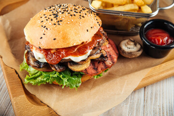 Closeup on mushrooms and tomato sauce burger set with fries and ketchup