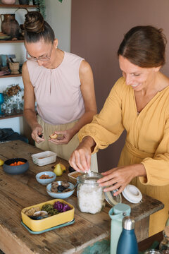 Smiling Women Preparing Food for a Lunchbox