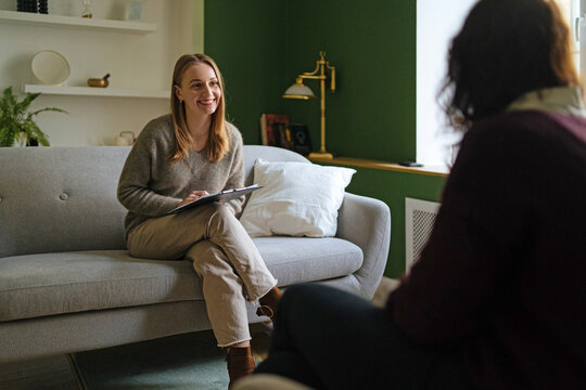 smiling woman psychologist talking to patient
