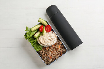 Thermos and lunch box with food on white wooden background, flat lay