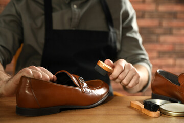 Master taking care of shoes in his workshop, closeup