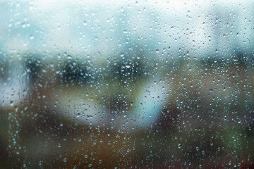 Rain drops on window glass surface. Rainy spring background