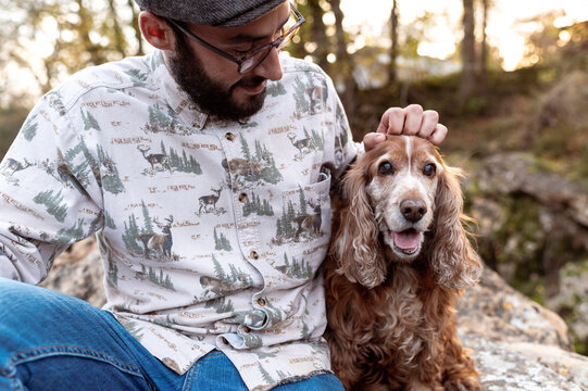 Young alternative man looking with loyaty to his pet
