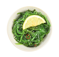Japanese seaweed salad with lemon slice in bowl isolated on white, top view