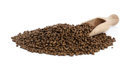 Buckwheat tea granules and wooden scoop on white background