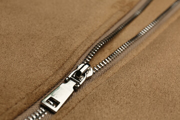 Beige jacket with zipper as background, closeup view