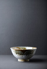 Traditional ceramic bowl on gray background. Soft focus. Copy space.
