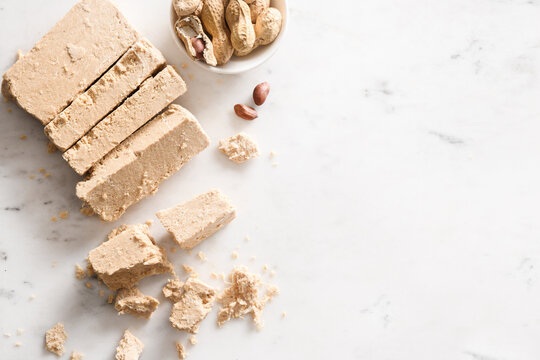 Peanut vegan dessert halva on white background.