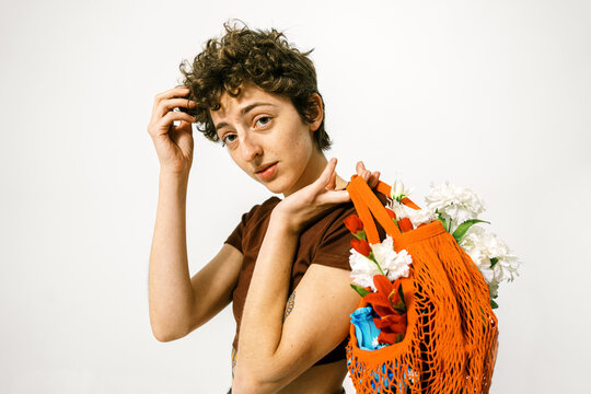 Androgynous woman with bouquet of flowers