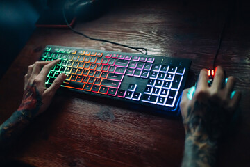 Multicolor gaming keyboard on table at evening