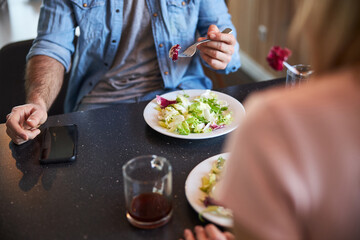 Young man having lunch with lady at home