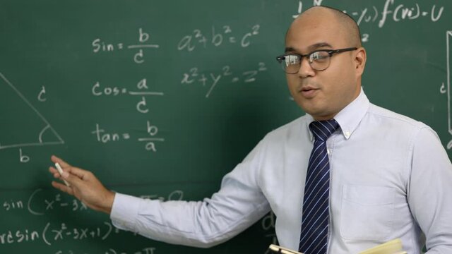 Young asian teacher man teaching video conference with student. Male Indian teacher training the mathematics in classroom from online course.