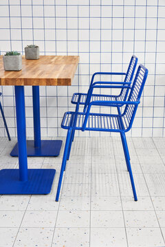 Chairs near wooden table in cafe