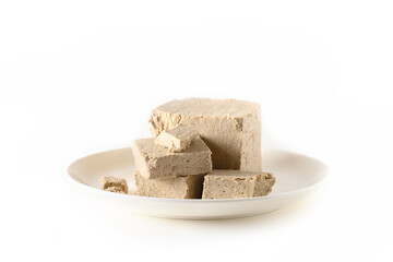 Sunflower halva in plate isolated on white.