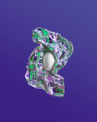 2021 Creative cyber Easter composition. Egg in aluminium foil with green and violet reflection on...