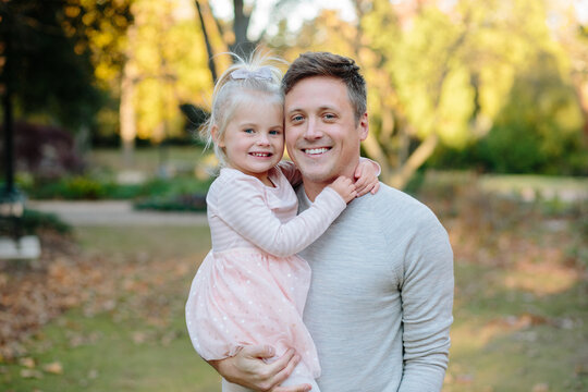 Young daughter hugging her dad