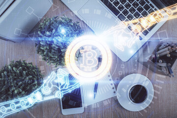 Double exposure of blockchain theme hologram over table with phone. Top view. Crypto technology...