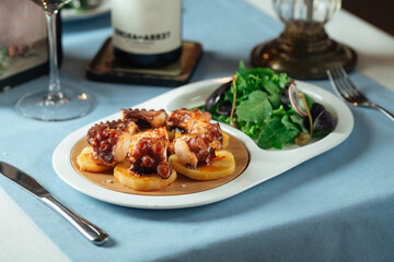 Spanish national cuisine dish galician octopus with potato and green salad