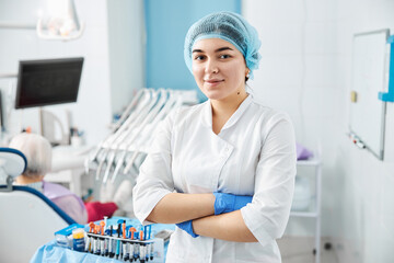 Woman dental surgeon crossing arms in clinic