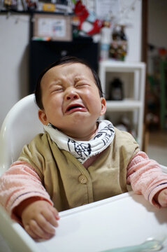 Cute Asian Little Boy Crying At The Dinner Table At Home