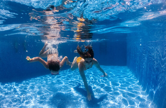 Two sisters in the pool at home